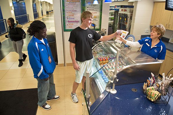 student receiving beverage from employee